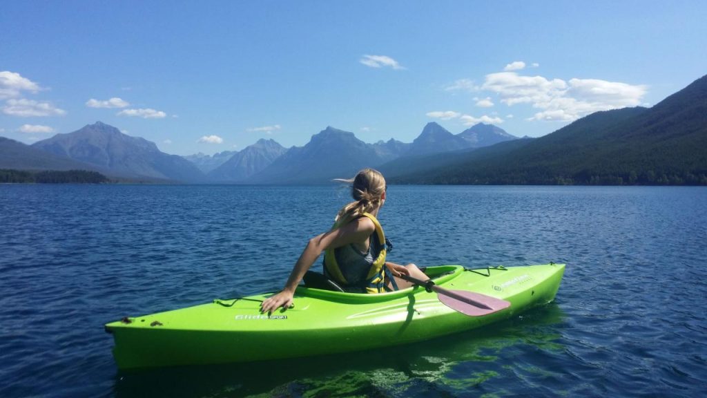 Girl Canoeing on Lake McDonald at Glacier National Park, Montana image ...
